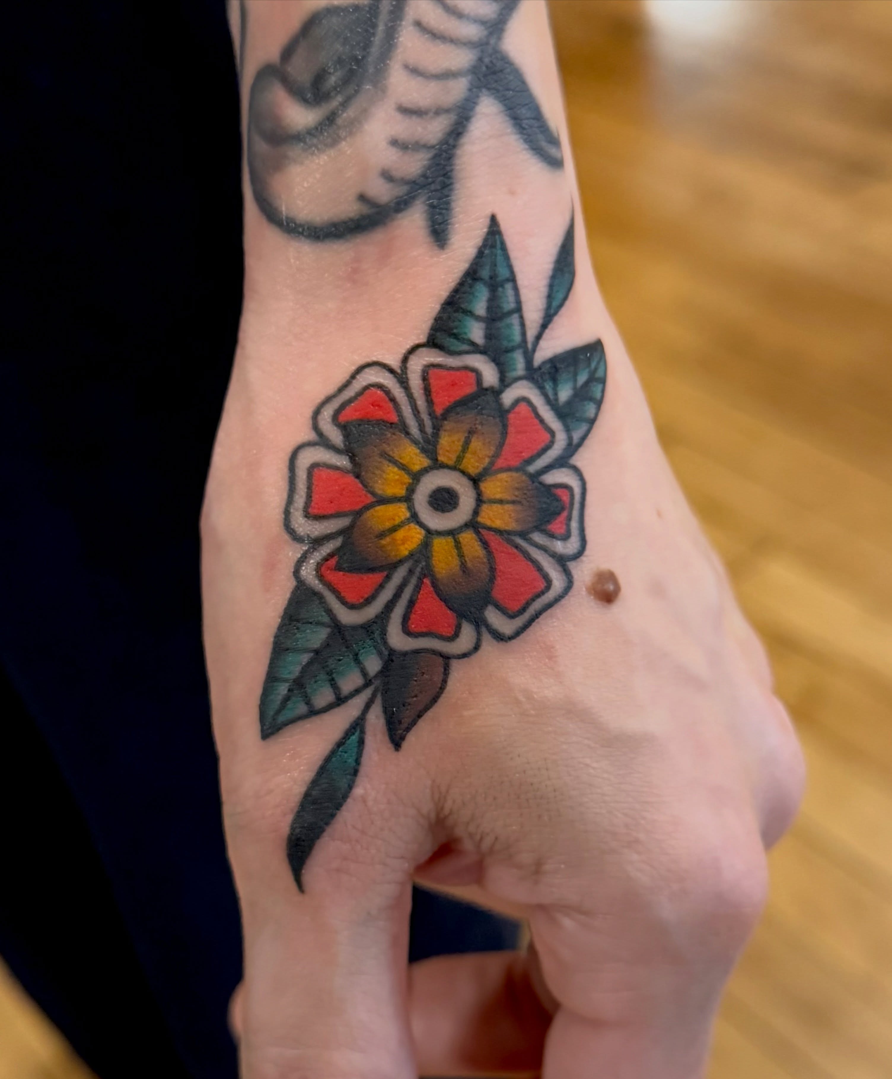 Flower American traditional tattoo on the forearm by Steven