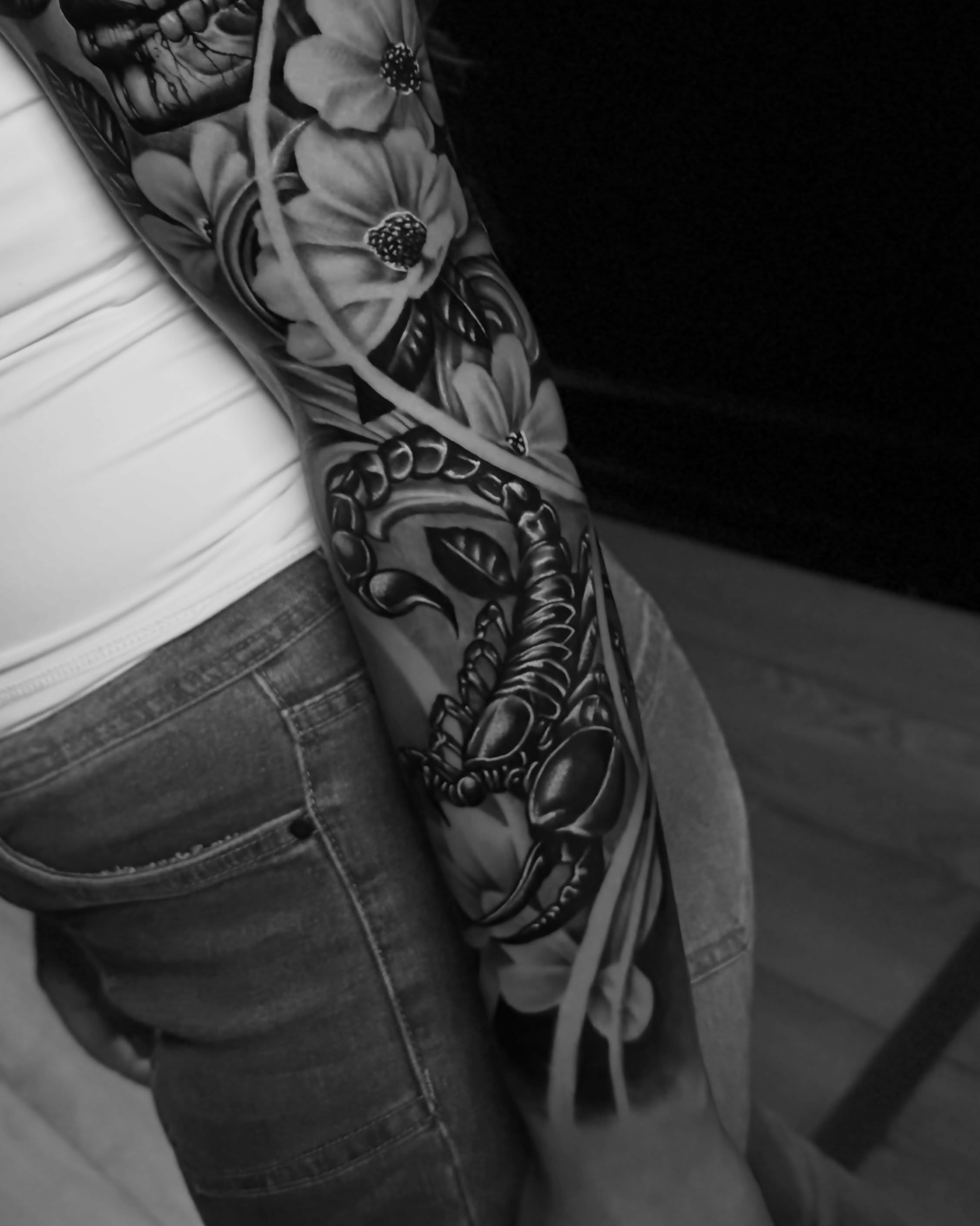 Scorpion and flowers realism tattoo on the forearm by Sebastian Calderon