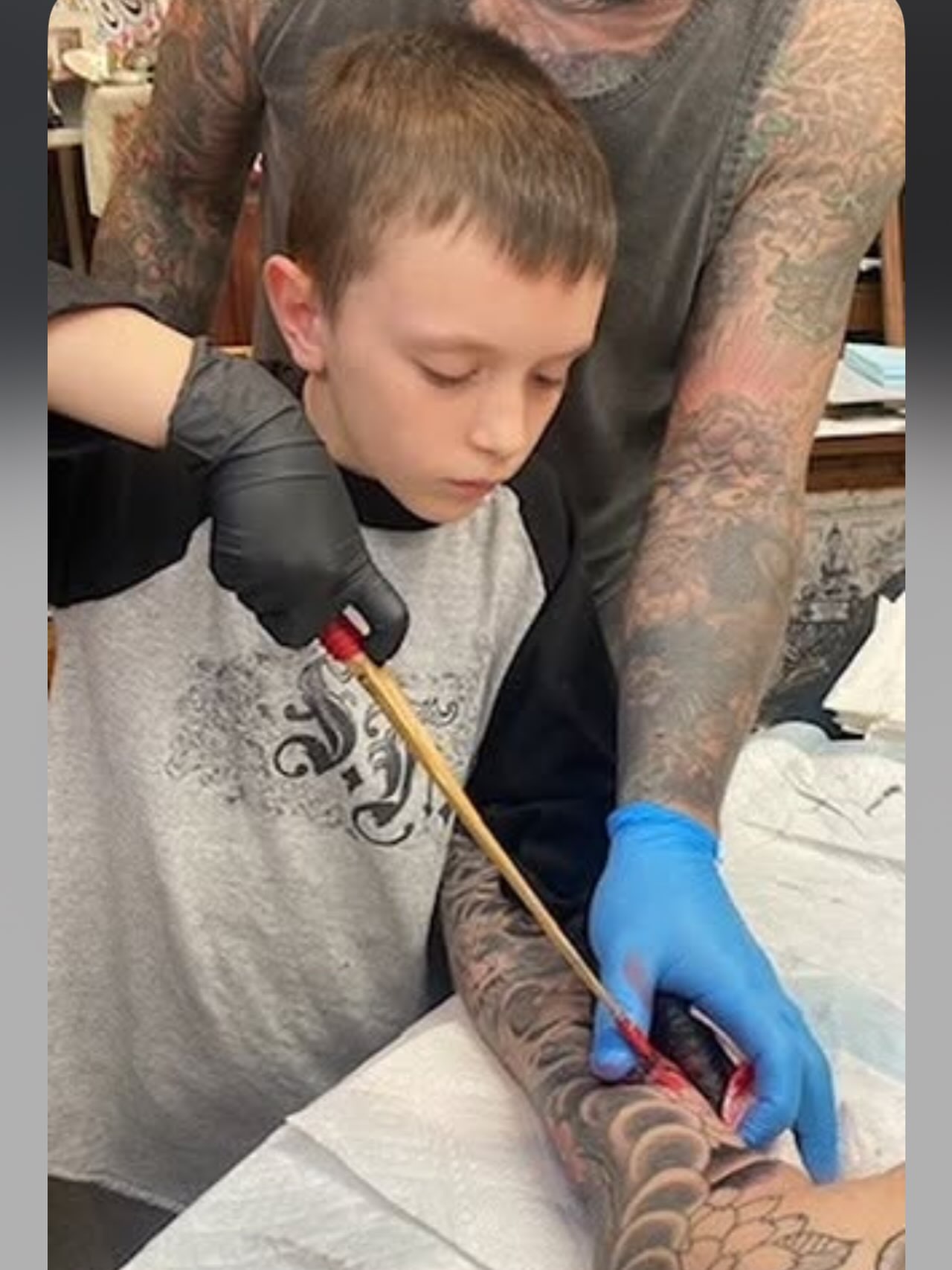 Fish scales black and grey tattoo on the upper arm by Jim Rosal