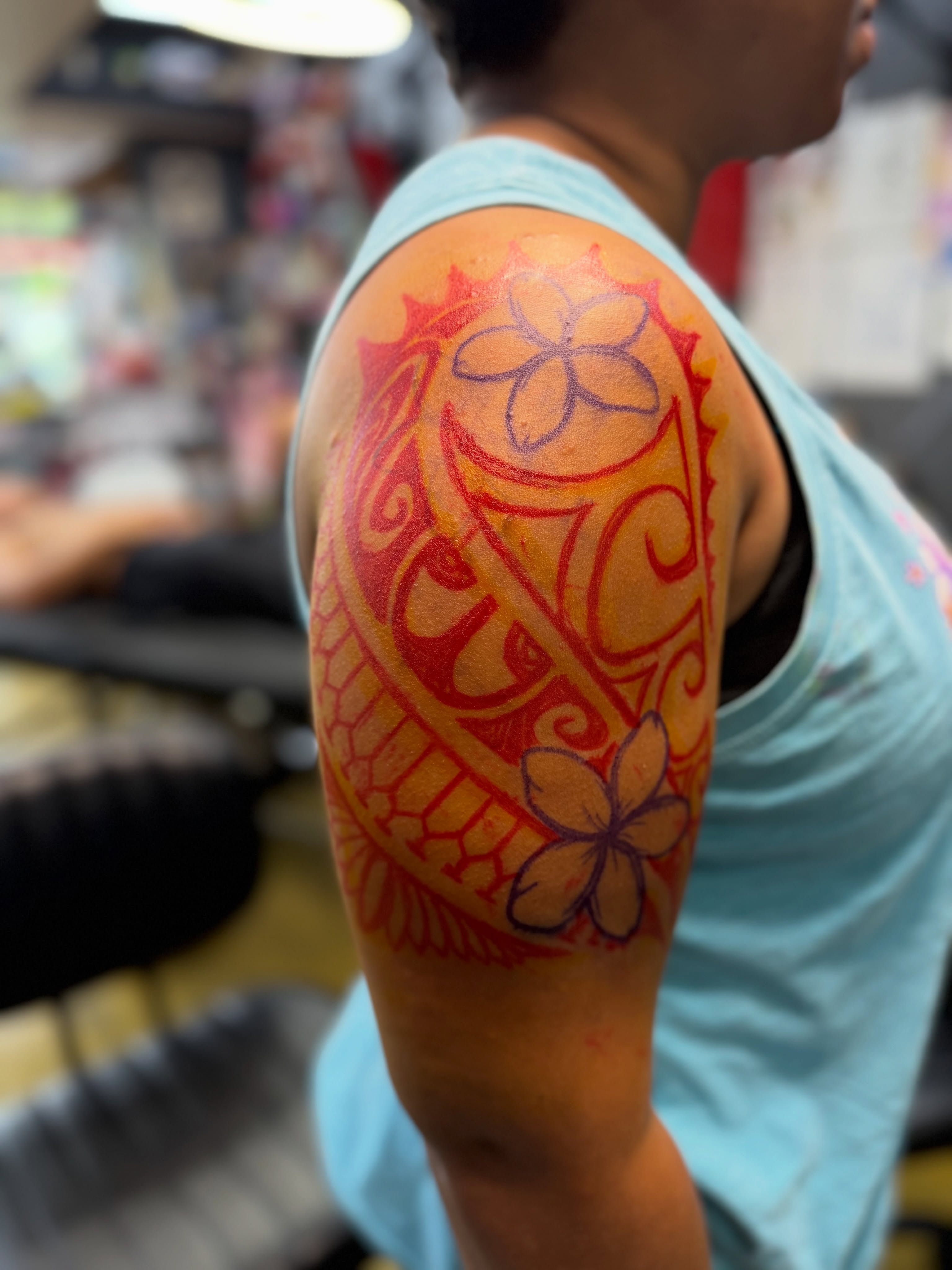 Plumeria flowers tribal tattoo on the shoulder by Shawn “Kluch” Hutto