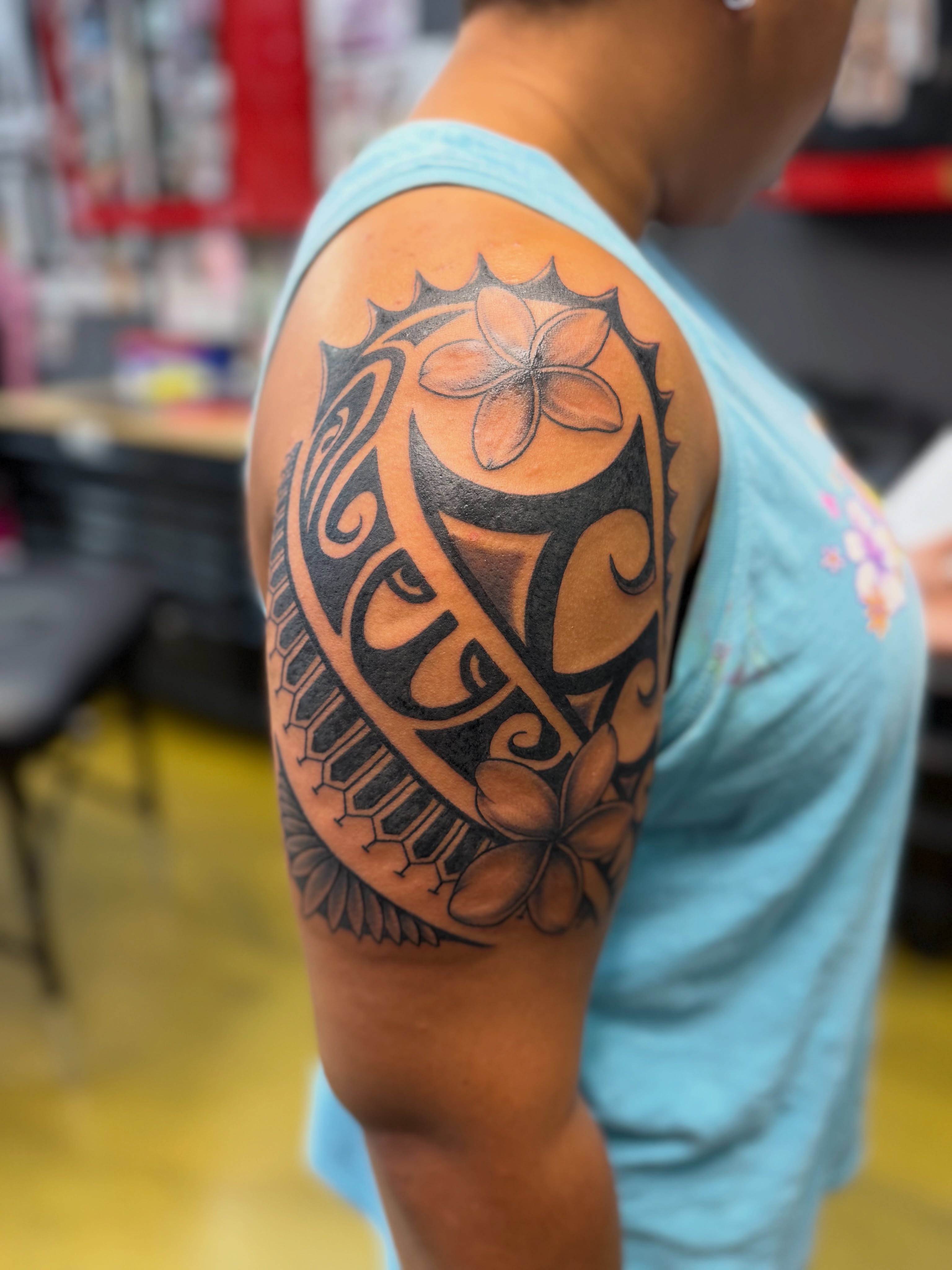 Plumeria flower tribal tattoo on the shoulder by Shawn “Kluch” Hutto