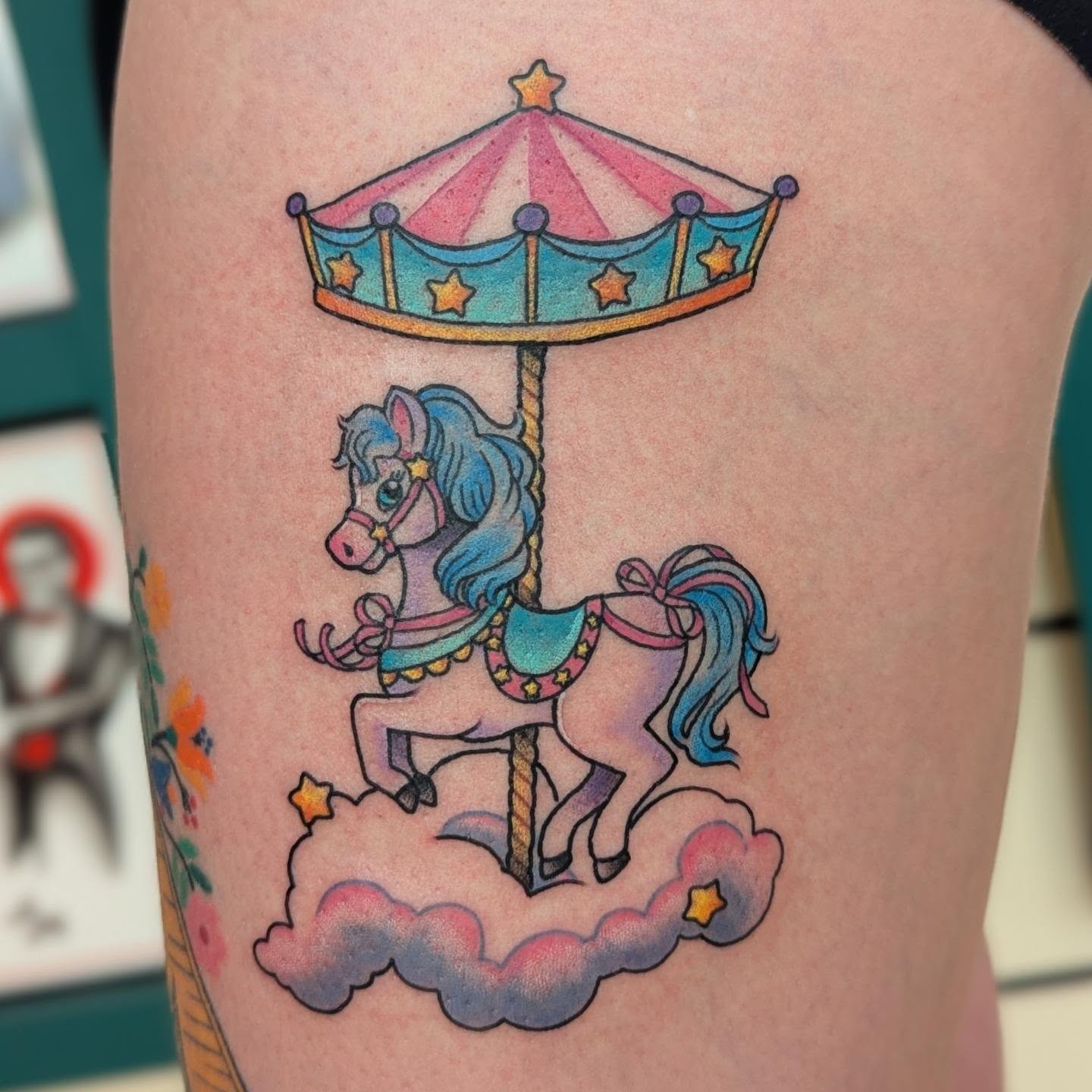 Carousel horse new school tattoo on the thigh by Angie Meuth