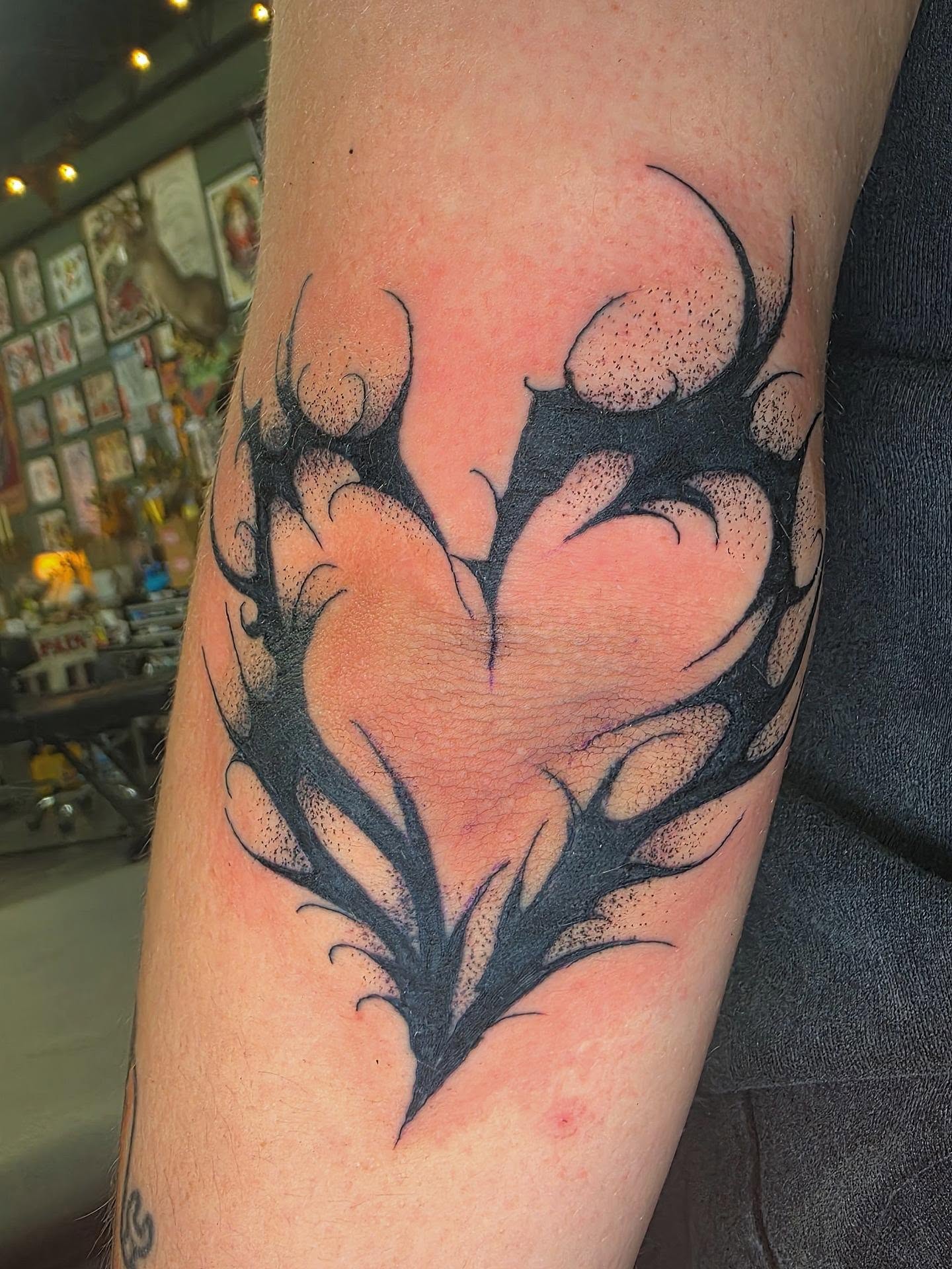 Heart with thorns dotwork tattoo on the forearm by Oliver Ⴟ Graves