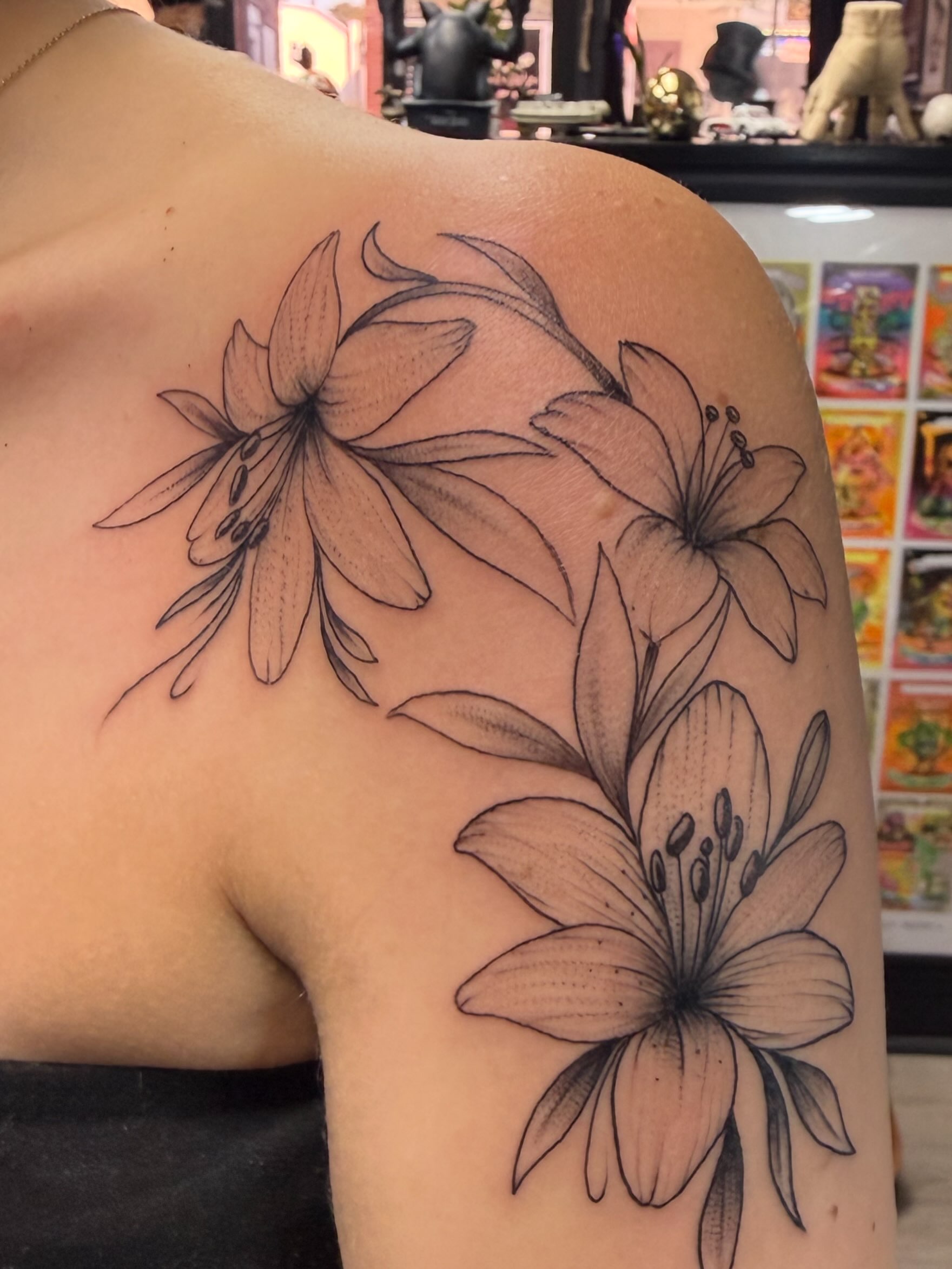 Lilies black and grey tattoo on the shoulder by Matthew Humphrey, Pawcatuck, Connecticut