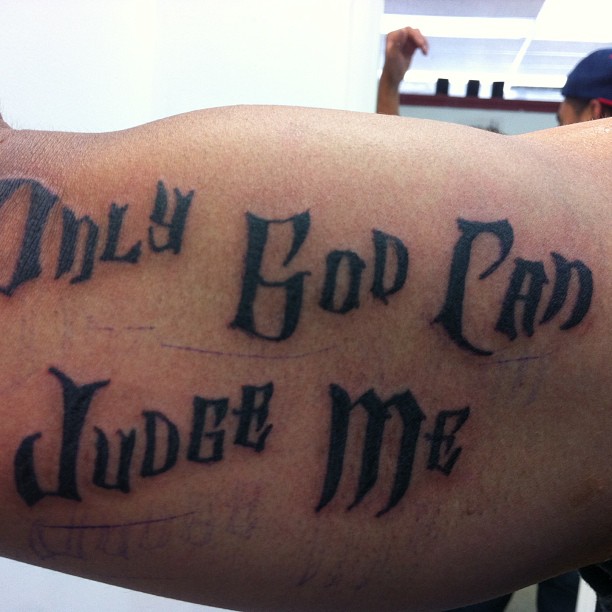 Only God Can Judge Me lettering tattoo on the upper arm by Kielin Green