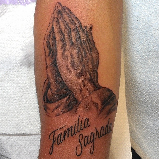 Praying hands realism tattoo on the forearm by @jaclyngreb