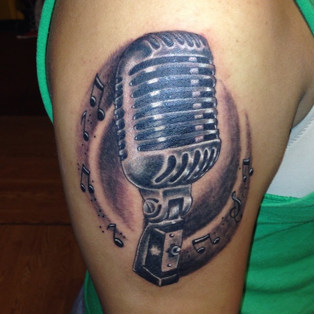 Microphone realism tattoo on the thigh by Zac Presley