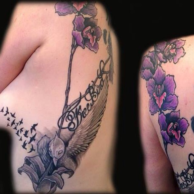 Bird and flowers realism tattoo on the thigh by Dharm, Denver, Colorado