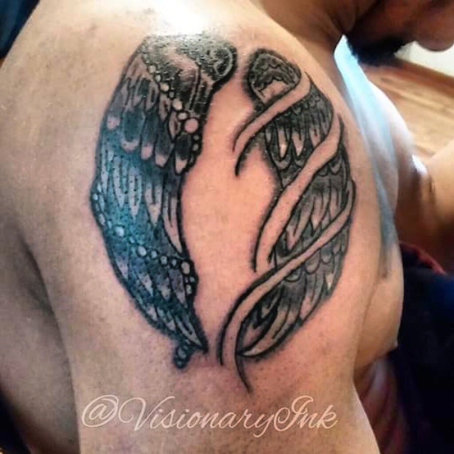 Winged creature black and grey tattoo on the shoulder by Visionary Ink