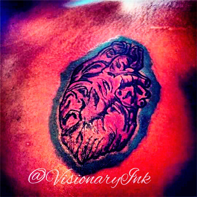Lion neo-traditional tattoo on the torso by Visionary Ink