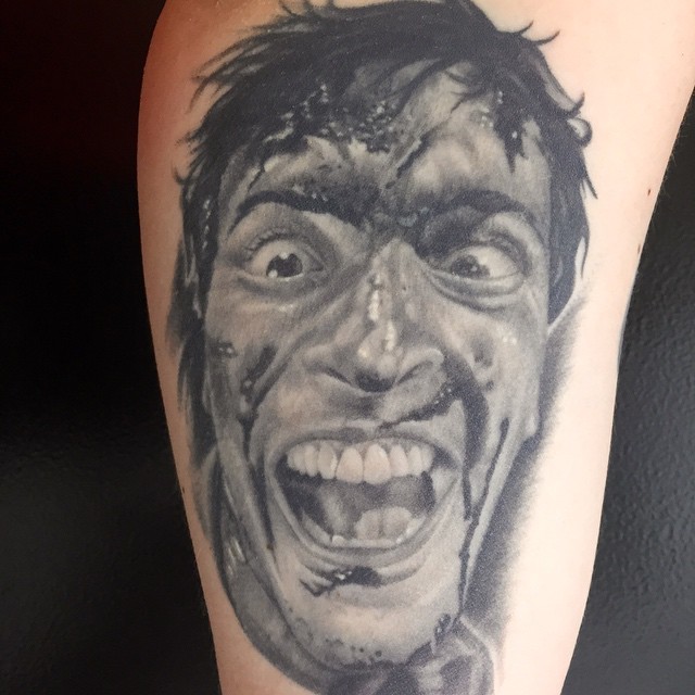 Angry face realism tattoo on the forearm by Jared Ammons