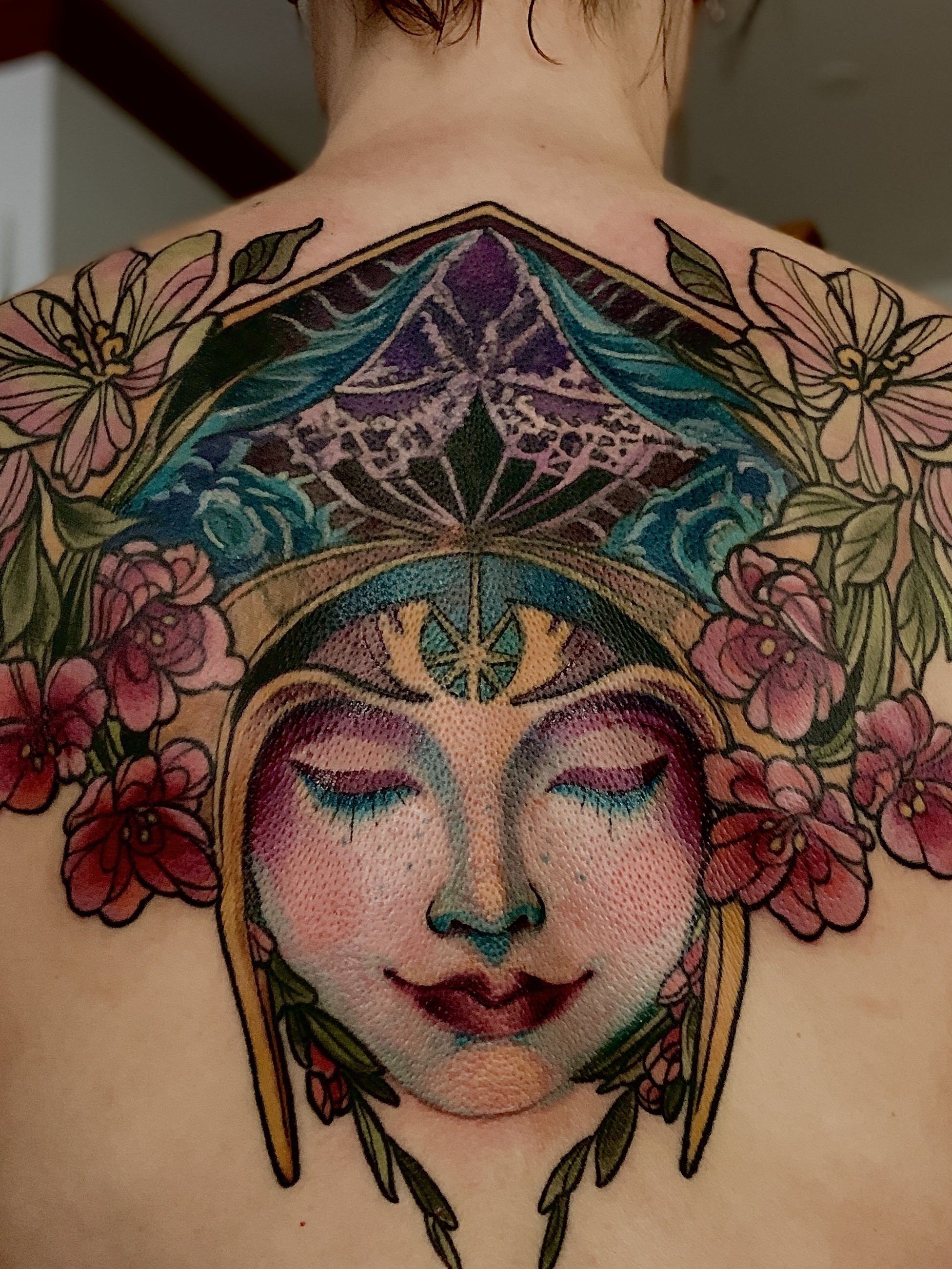 Woman's face with floral elements neo-traditional tattoo on the back by Mila Tattoo Riga ( Krazzoo ), Riga