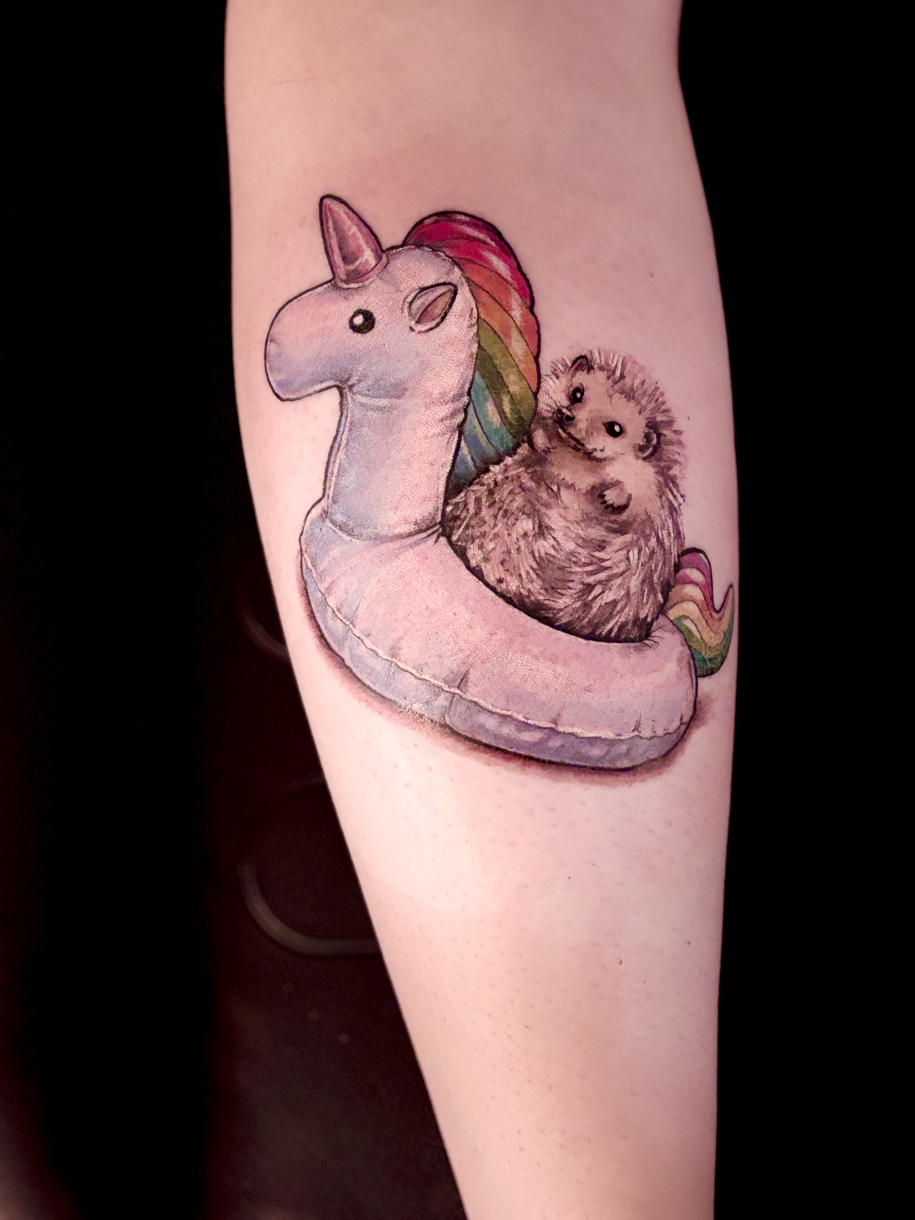 Hedgehog on a unicorn float tattoo on the forearm by Mila Tattoo Riga ( Krazzoo ), Riga